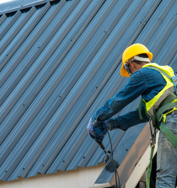 worker installing metal roofing